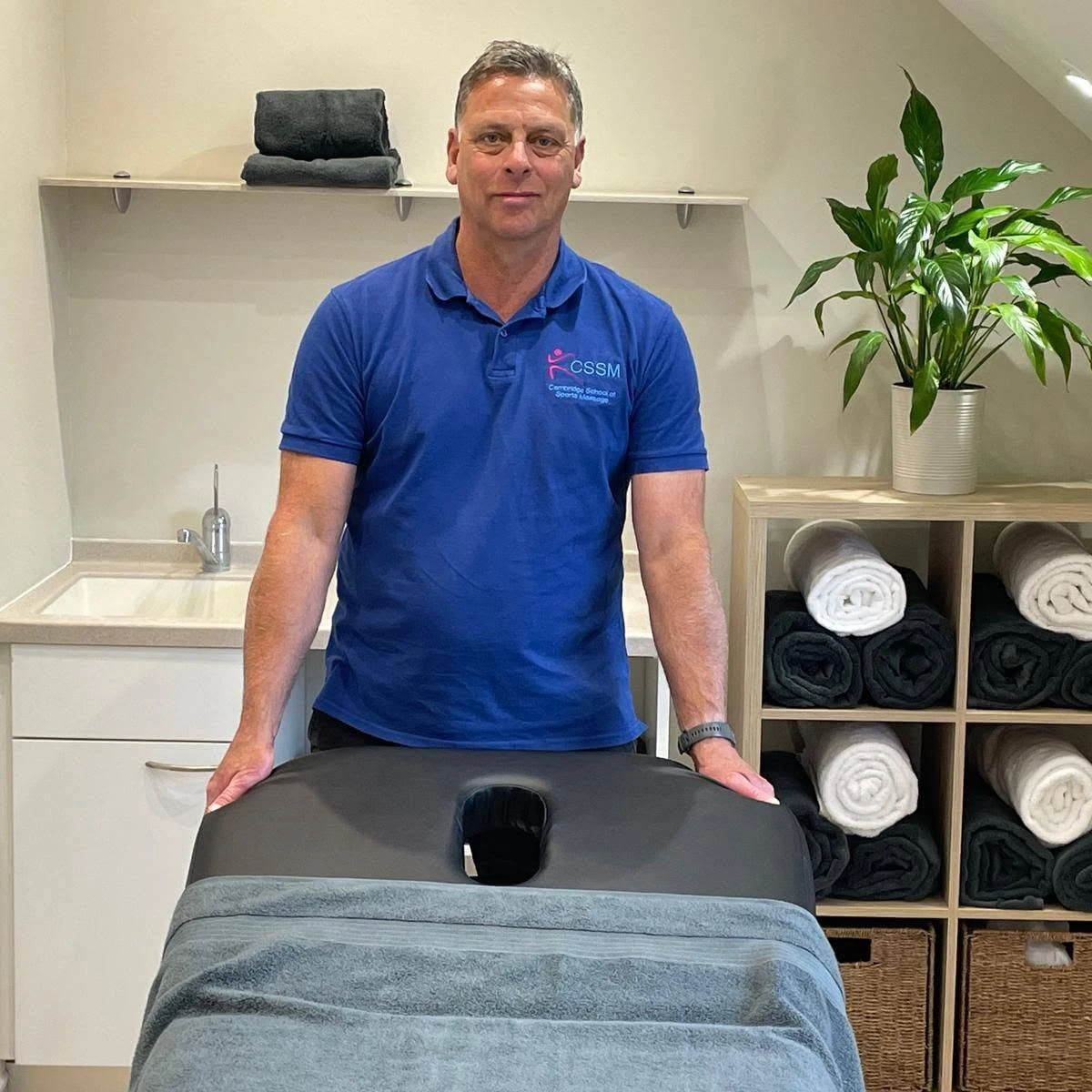 Andy Blacklock standing at his massage table
