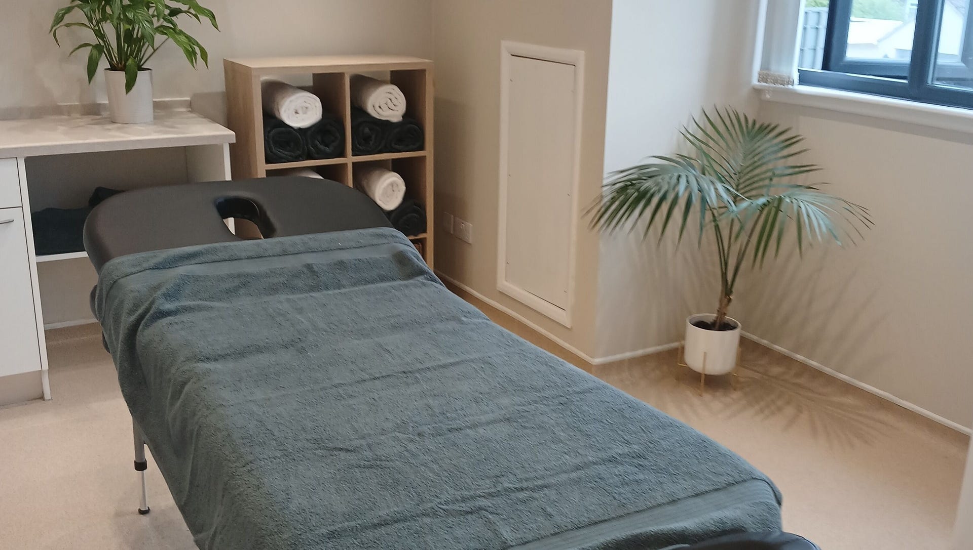 Massage table with fresh towels in the treatment room
